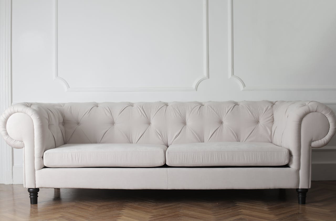 Mastering the First Impression: Your intriguing post title goes here Luxurious white sofa in a modern minimalist interior with wooden flooring.
